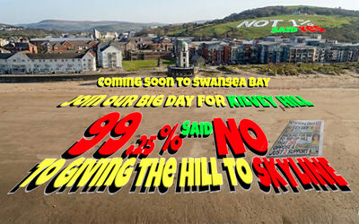 Drone shot of people on the beach forming text